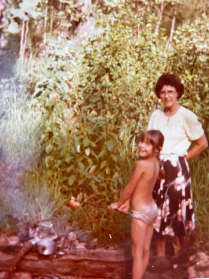 Young Belinda with her Nan cooking out in the NT bush